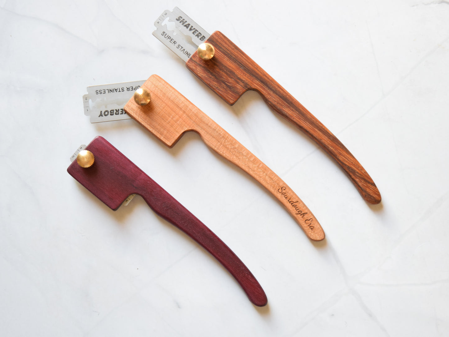 Retractable wooden bread lame with handle, shown in all positions