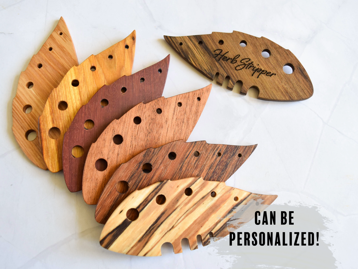 Set of wooden herb stripper tools with different wood finishes on a white background.